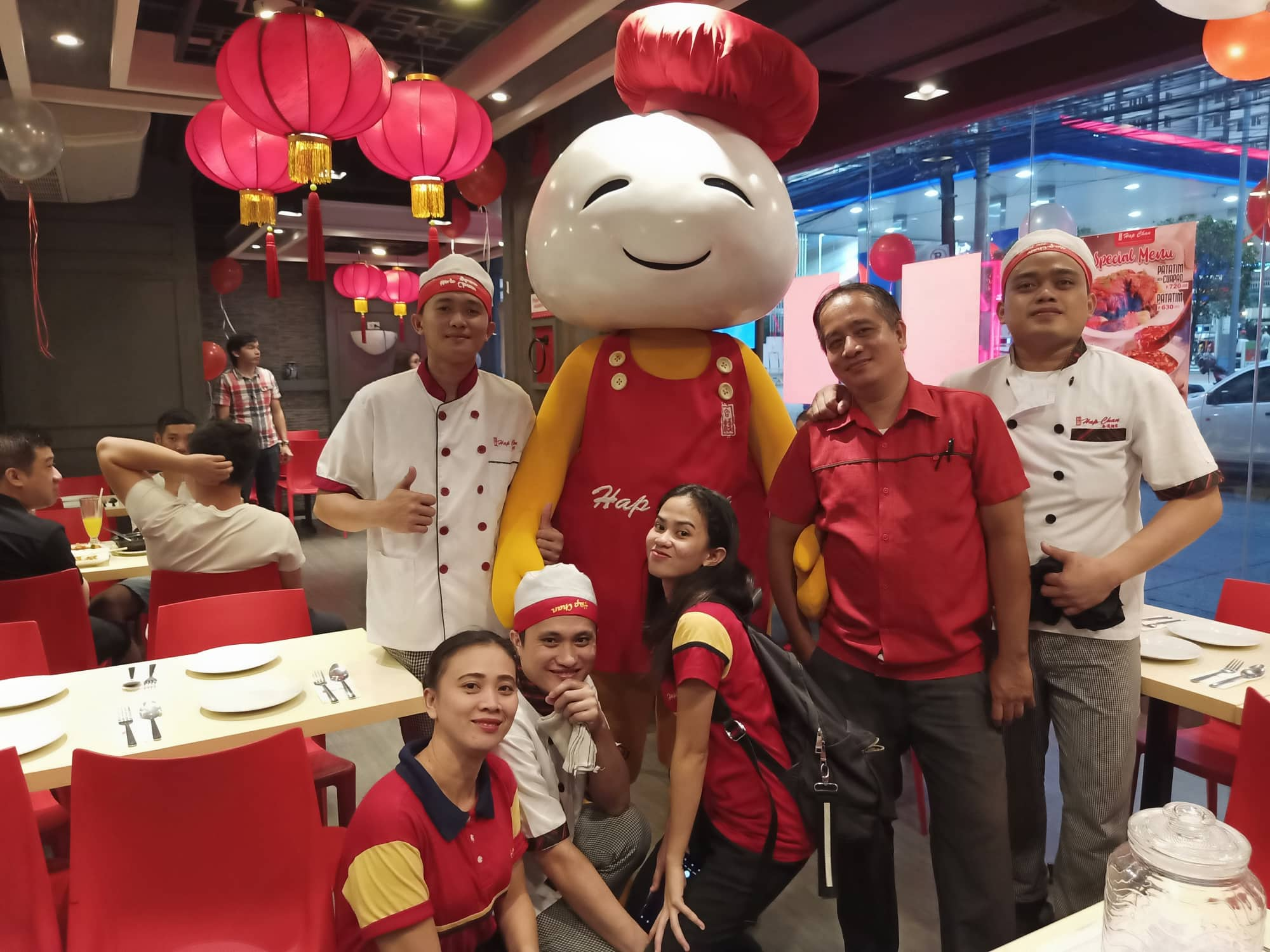 group of hap chan staff smiling with hap chan mascot