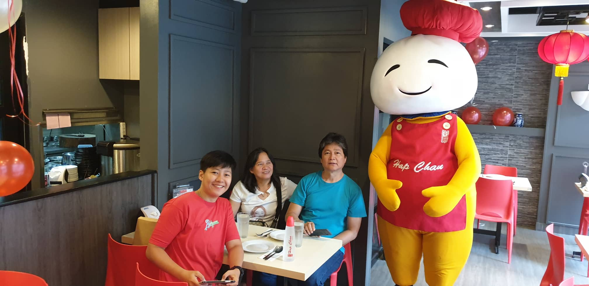 customers smiling with hap chan mascot